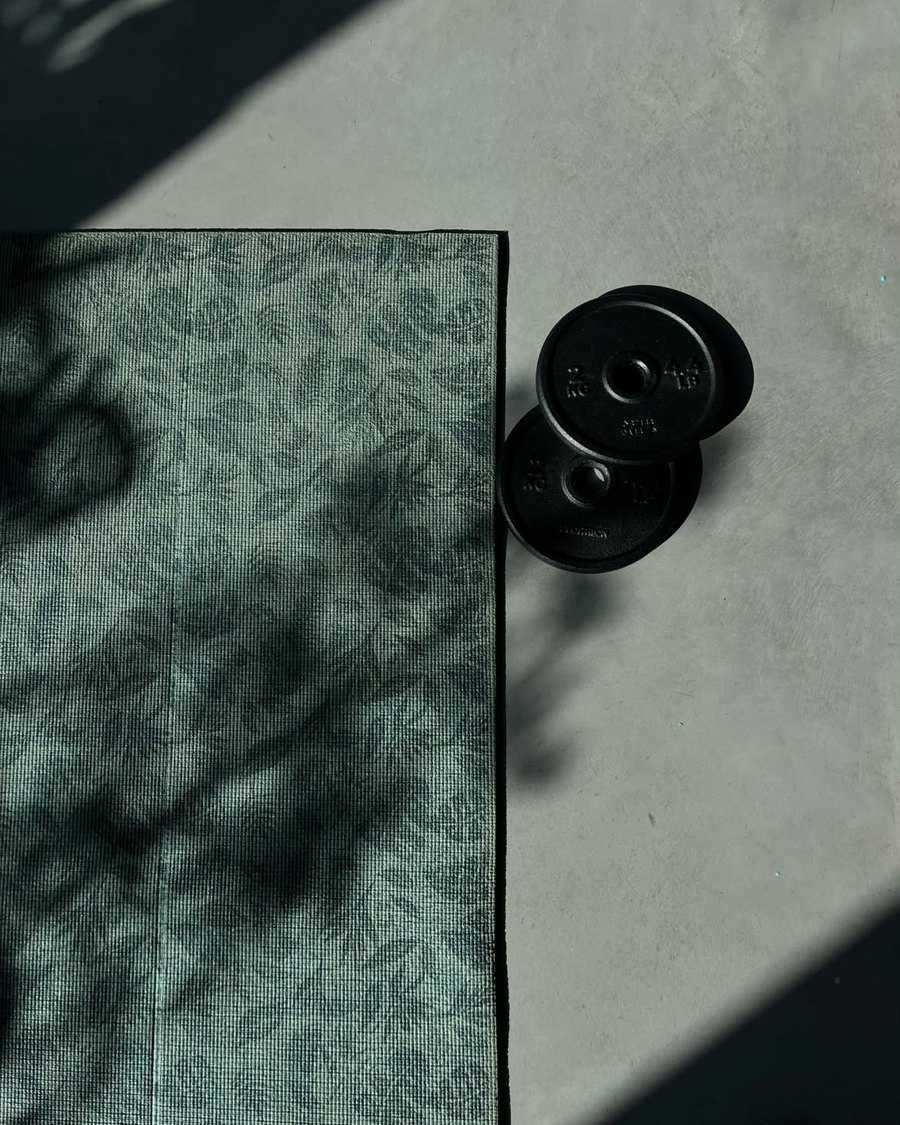 Mat and weight plates on the studio floor
